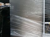 a refrigerator and a refrigerator freezer sitting in a warehouse
