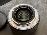 a camera lens sitting on a table next to a camera lens cap