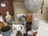 many different types of pottery displayed on a table