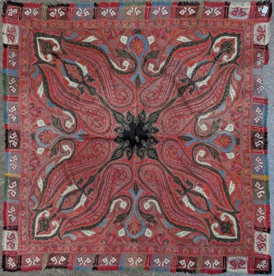 a close up of a red and blue rug on a blue floor