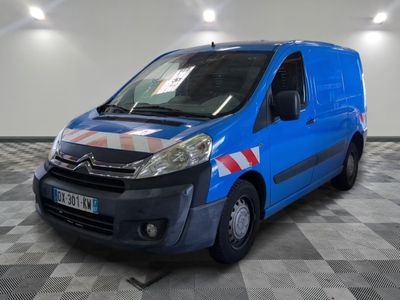 the blue van is parked on a checkered floor in the garage