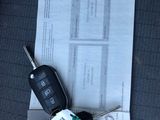 a car key sitting on top of a piece of paper
