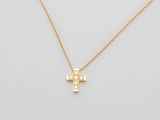 a gold cross necklace with diamonds on a white background