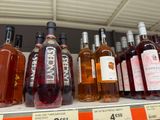 many bottles of wine sitting on a shelf in a store