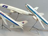 three model airplanes that are on display on a table