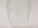 a glass cup with a design on it on a white surface