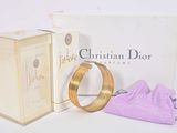 a box with a ring on it next to a purple bag