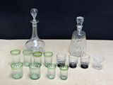 many glasses and a decanter sitting on a table
