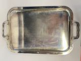 a silver tray with a handle on a table