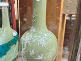 two vases on display in a glass case