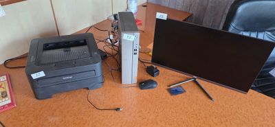a desk with a computer, printer, mouse, and a monitor
