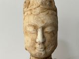 a stone statue of a person with a hat on