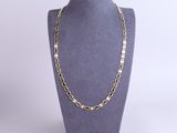 a gold chain necklace on a mannequin mannequin display