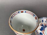 a small cup and saucer sitting on a table