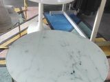 two tables that are sitting on the floor in front of a mirror