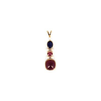 a gold pendant with three different colored stones on a white background