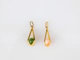 a pair of gold earrings with green and pink stones