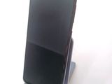a cell phone that is sitting on top of a stand