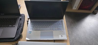 two laptops that are sitting on a table
