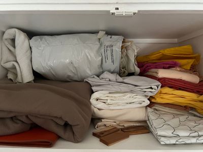 a picture of a closet full of clothes and blankets