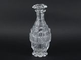 a clear glass vase on a black surface with a black background
