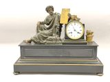 a statue of a woman sitting on top of a table with a clock