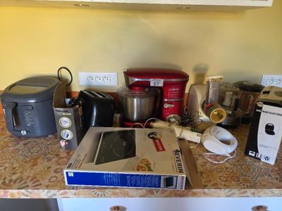 a counter top with a bunch of appliances on it