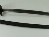 pair of old swords on a white table with a black handle