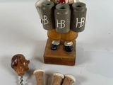 a figurine of a man holding a bottle of wine next to a cork stopper