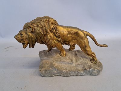 a statue of a lion on a rock on a white surface