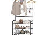 a black metal rack with shoes and clothes hanging on it
