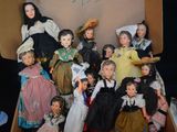 many dolls in a box that are sitting on a table