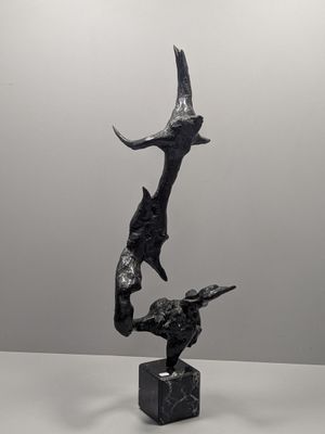 sculpture of a bird and a fish on a marble base