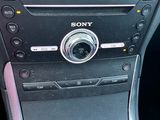 a close up of a car ' s radio and steering wheel