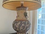 a lamp that is sitting on a table in front of a window
