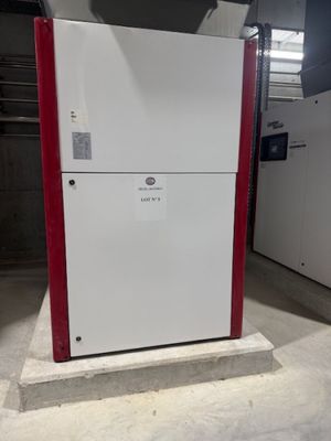a white refrigerator with a red door in a room