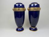 pair of blue and gold vases with handles on each side