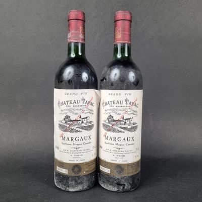 two bottles of red wine sitting next to each other on a table