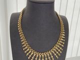 a close up of a mannequin with a necklace on it