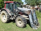 a tractor that is parked on the grass in the yard