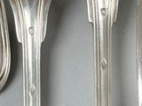 three forks and spoons that are on the wall