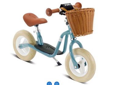 a small blue tricycle with a basket on the back