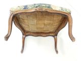 a wooden bench with a floral seat cushion on it