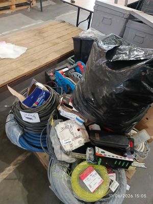 a pile of assorted items on a table in a warehouse