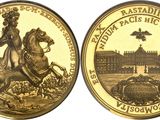 a close up of two gold coins with a woman on a horse