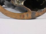a bronze sculpture of a cat sitting on top of a rocking horse