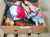 a box full of clothes sitting on a wooden bench