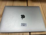 an apple macbook is sitting on a table with a price tag on it