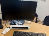 a computer desk with a keyboard, mouse, and monitor