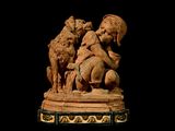 a statue of a child and two dogs on a pedestal